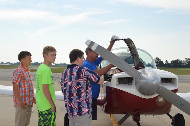 Pilot Neil Straub doing a preflight with his passengers.
