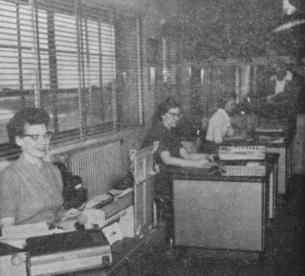 A snap shot catches the office girls busy with the day's work. The huge sailfish on the rear wall suggests a touch of J.E.'s interests and was caught on a Mexican vacation.