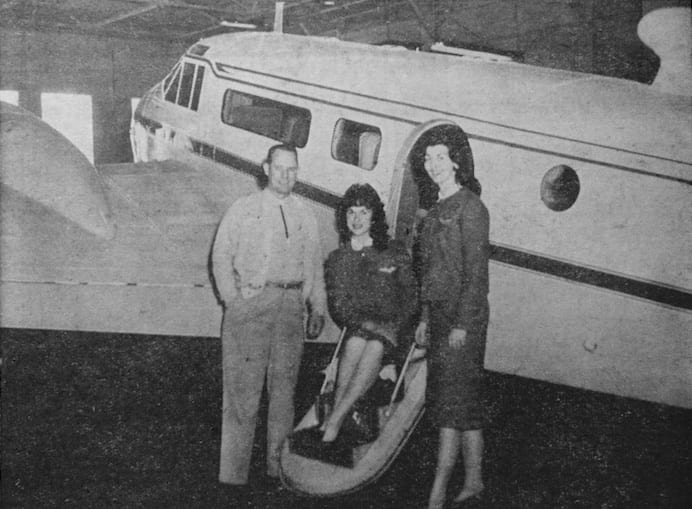 FLYERETTES INSPECT COMPANY PLANE – J.E. Dyer, president and General Manager of Univair conducted the Northwest Flyerettes on a tour of the plant and facilities. Shown above the girls stop for a rest by one of the four planes owned and operated by the company. The girls (l to r), are: Dorothy Campadore and Deanna Robinson.