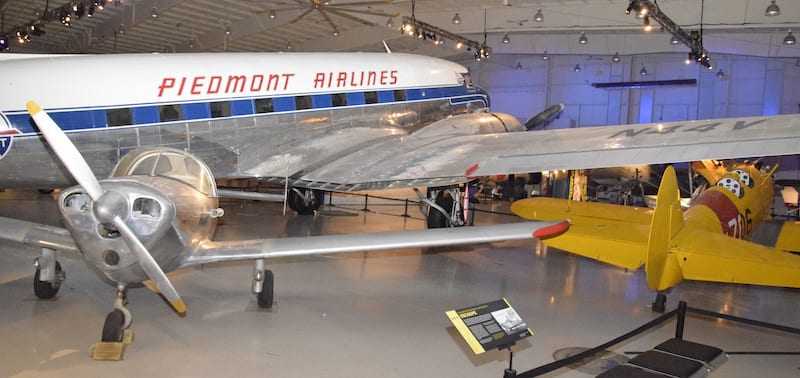Three classic aircraft at the Carolinas Aviation Museum are grouped together. They are the 415-C Ercoupe, the Boeing Stearman and the DC-3. 