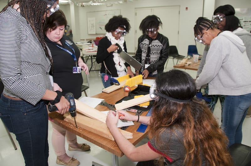 A middle school group takes part in an engineering challenge during a student camp at the Carolinas Aviation Museum.