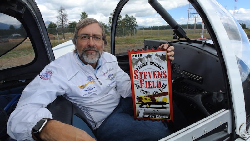 Air Racer William E. Dubois with his First Place “trophy” for a win in his Class (of course his was the only plane in its class in this race). Many pilots are afraid to fly low-powered planes in the Mountains, but Dubois originally learned to fly in the Colorado mountains so it was home turf for him. (Photo by Lisa F. Bentson)