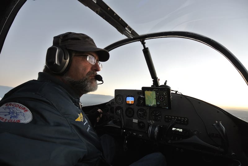 Pre-dawn en route from Farmington, New Mexico to Pagosa Springs, Colorado, air race pilot William E. Dubois is worried about ground fog with a dew point temperature spread of zero. In the chilly morning air, the 85-horse power plane quickly climbed above the mountainous terrain. (Photo by William E. Dubois) 