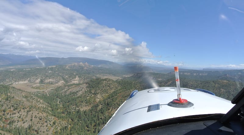 On the final leg of the race, Chimney Rock is at the 11 O’clock position off the nose. Air racer William E. Dubois is preparing to dive for the finish line, which is over the next ridge. (Photo by William E. Dubois)