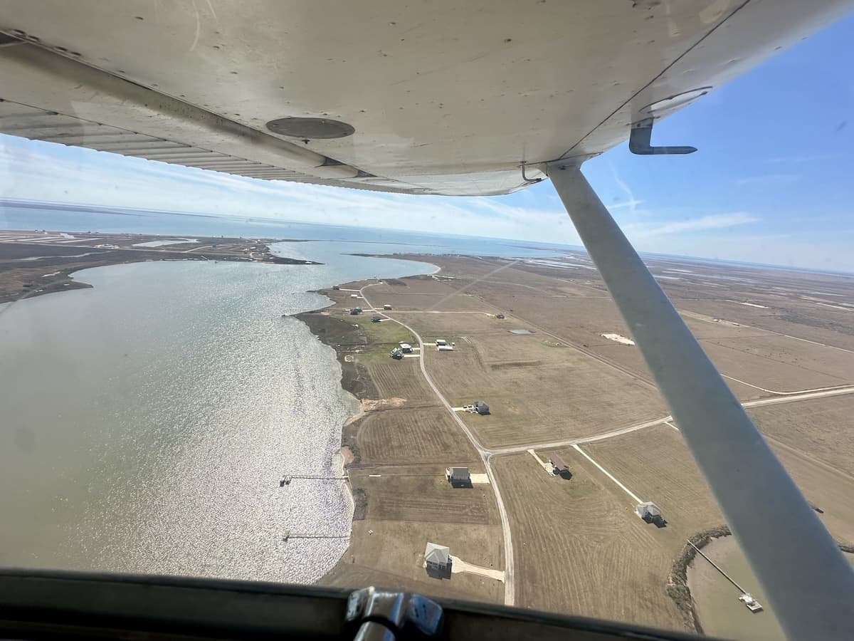 Aerial view of the Palacios, Texas coastline taken from a general aviation aircraft cockpit during a 500-hour flight milestone.
