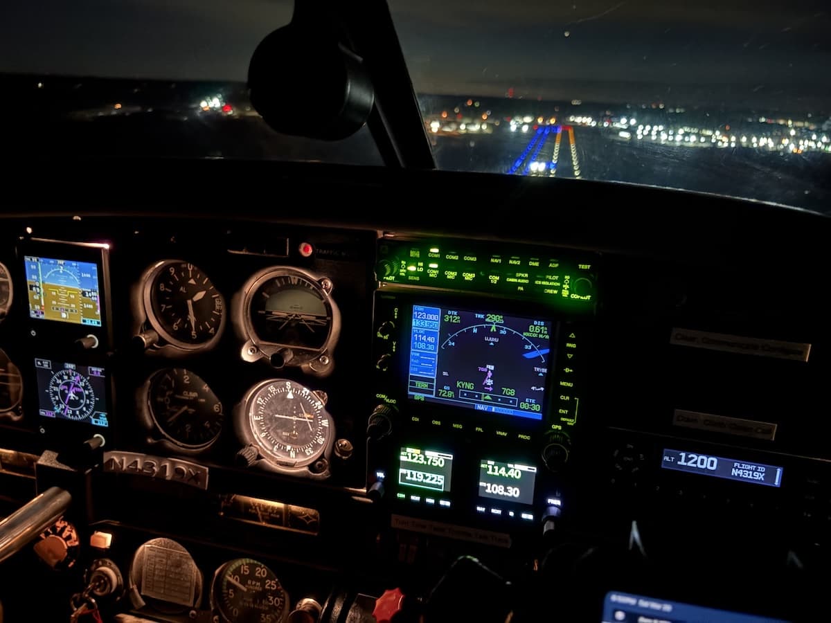 Cockpit view of a Piper PA-28-181 during a night flight approach to Geauga County Airport with LED runway and taxiway lights leading the way home.