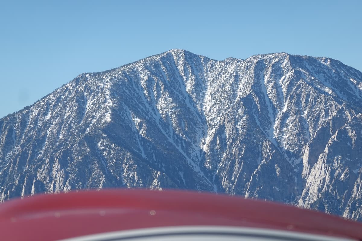 Snow-covered Mount San Jacinto peak viewed from the cockpit of a SOCATA Trinidad TB-20 flying over the LA basin.