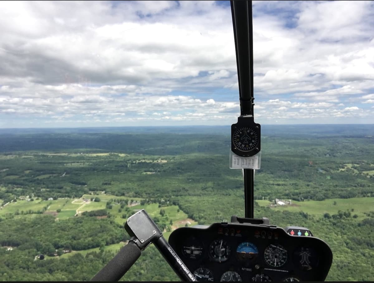 Cockpit view of the springtime Connecticut countryside during a solo Robinson R22 helicopter flight.