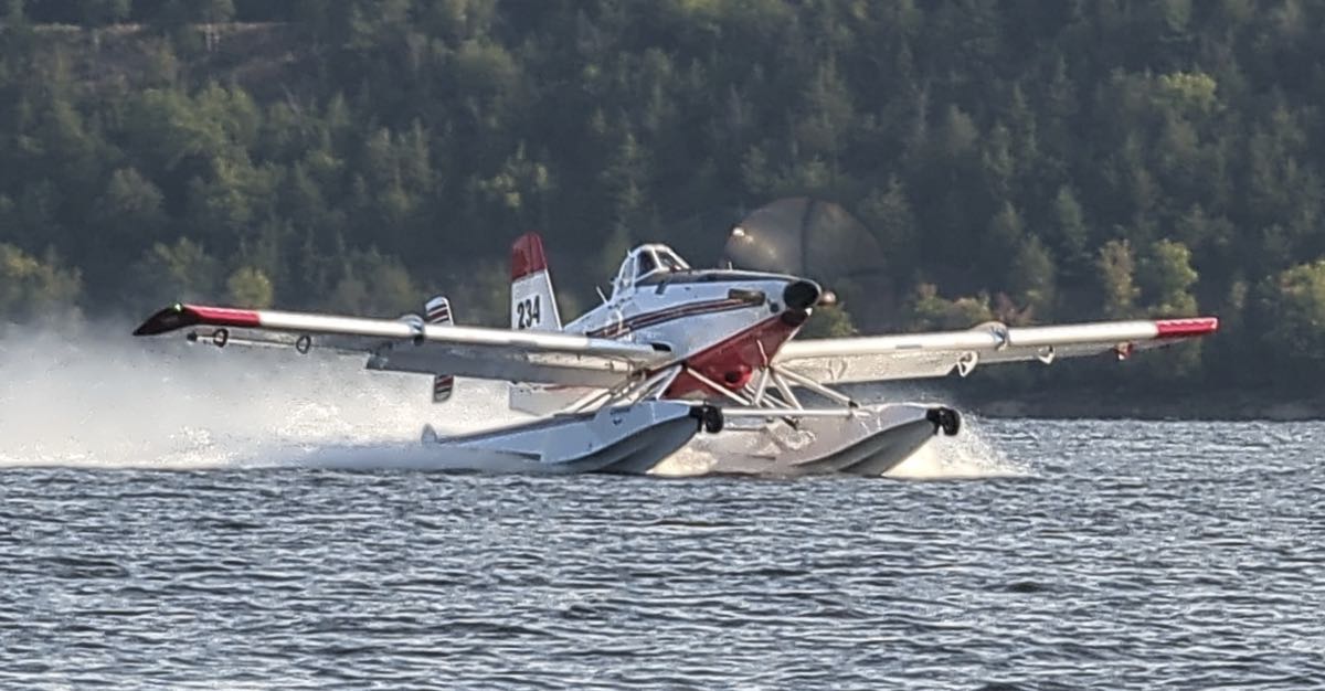 An Air Tractor AT-802A firefighting aircraft equipped with Momentum Aeronautics Heatwave amphibious scooping floats.