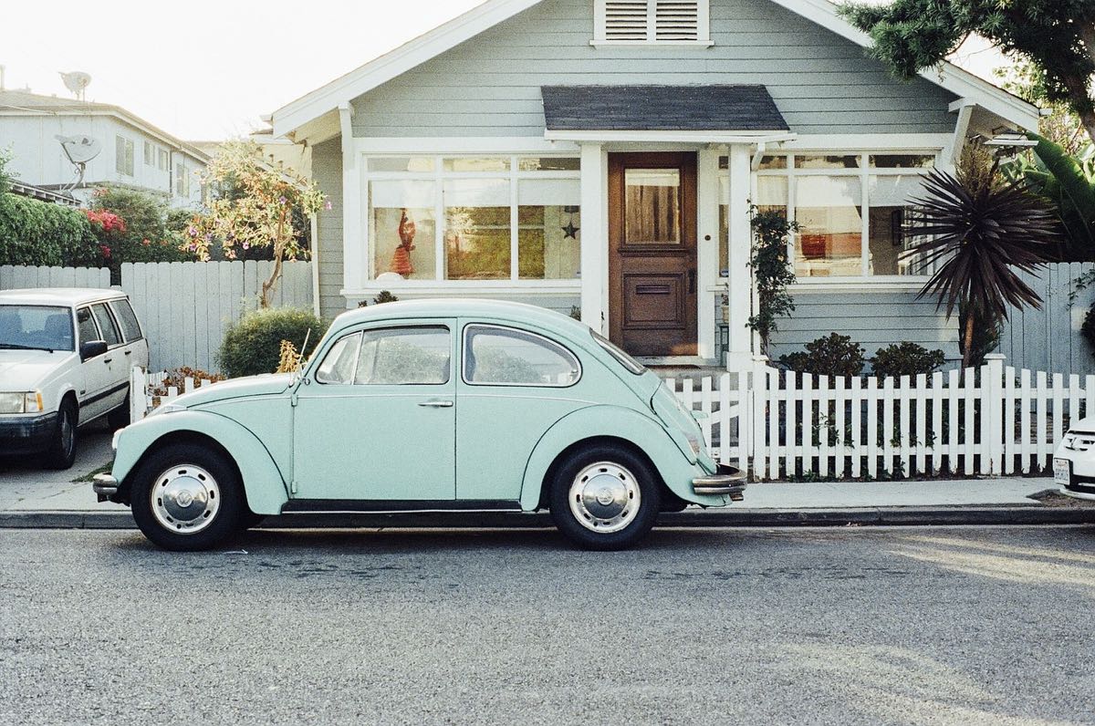 Classic 1964 vintage Volkswagen Beetle in pale green representing minimal transport