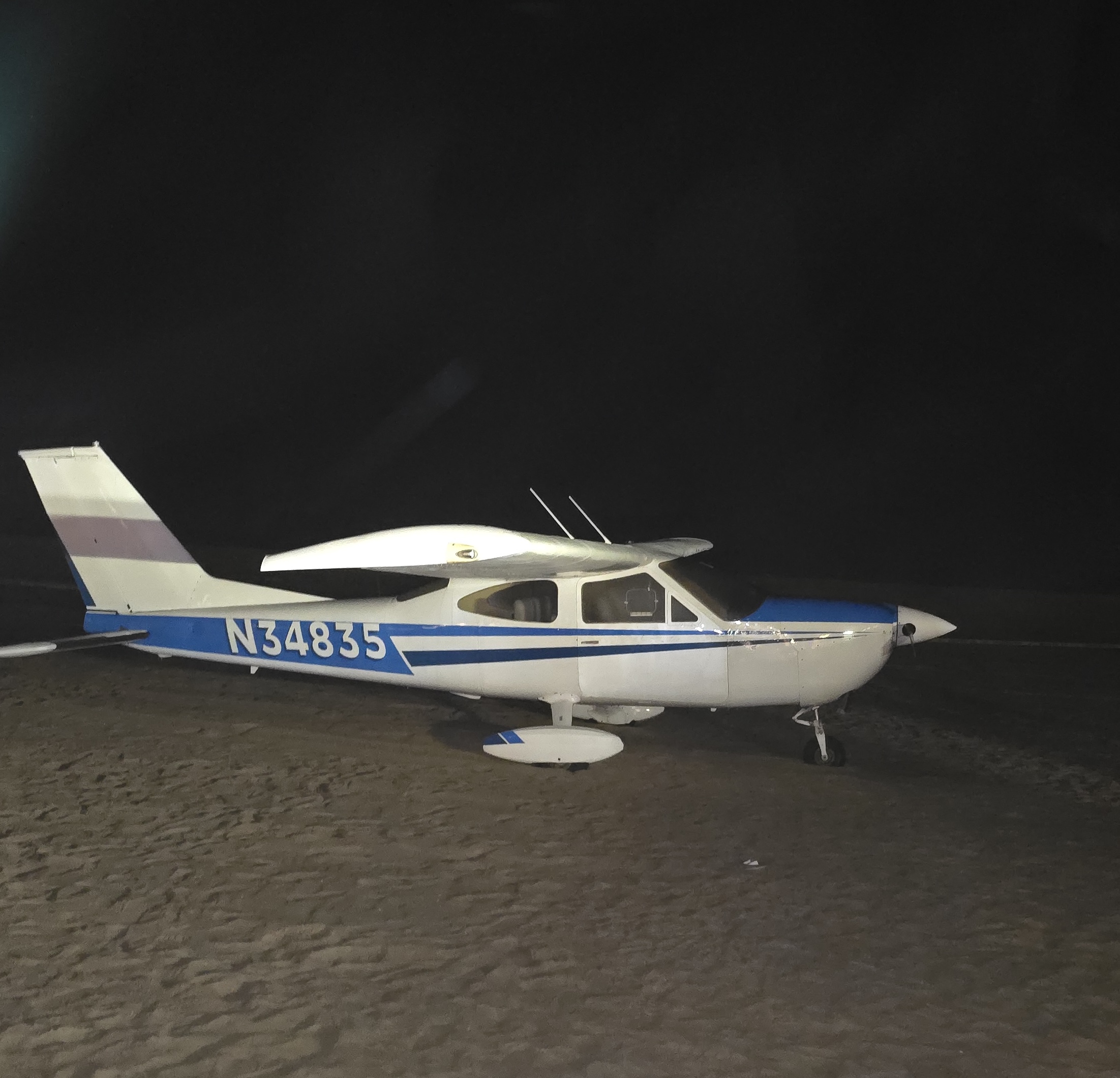 Cessna Cardinal rests on Huntington Beach sands following an emergency landing.