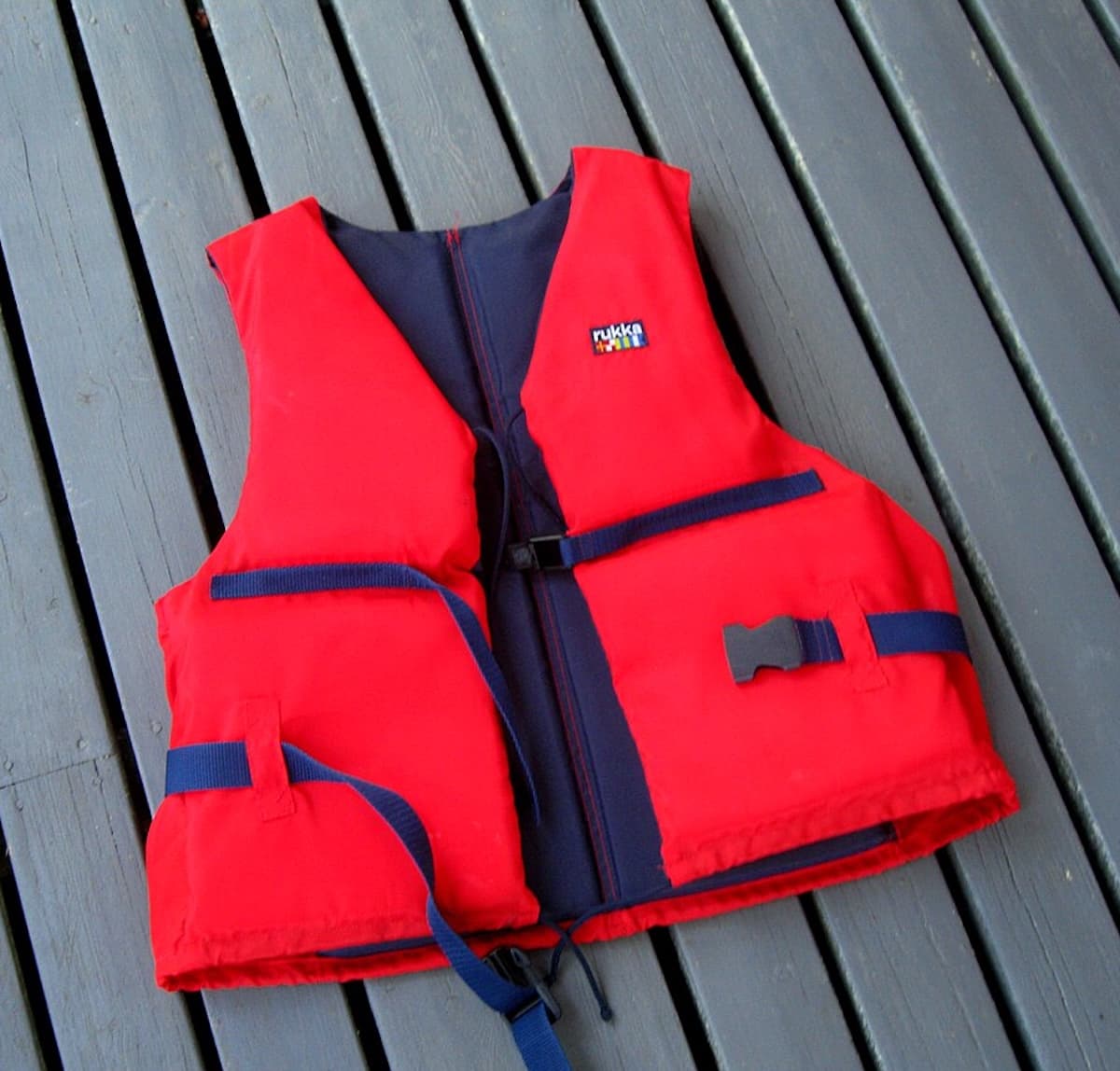 A bright red life jacket representing aviation safety and survival equipment.
