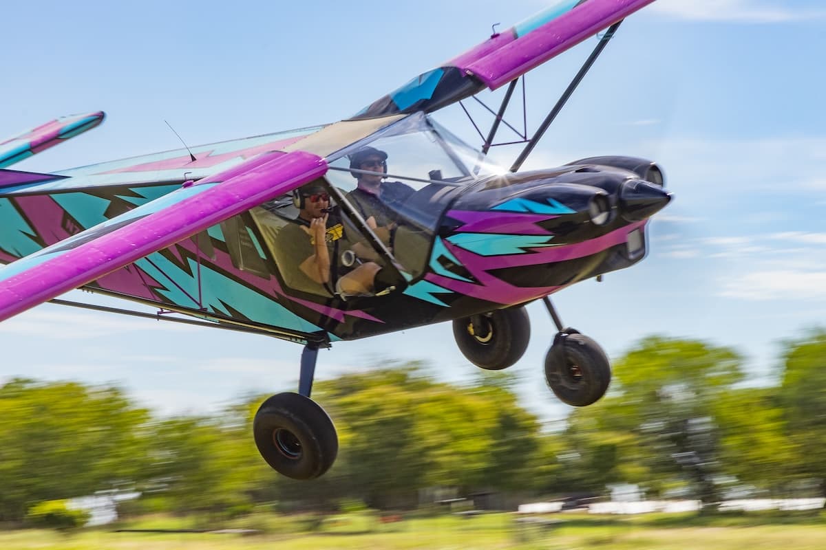 Zenith homebuilt aircraft performing a low fly-by pass over the turf runway at historic Ranger Airfield.