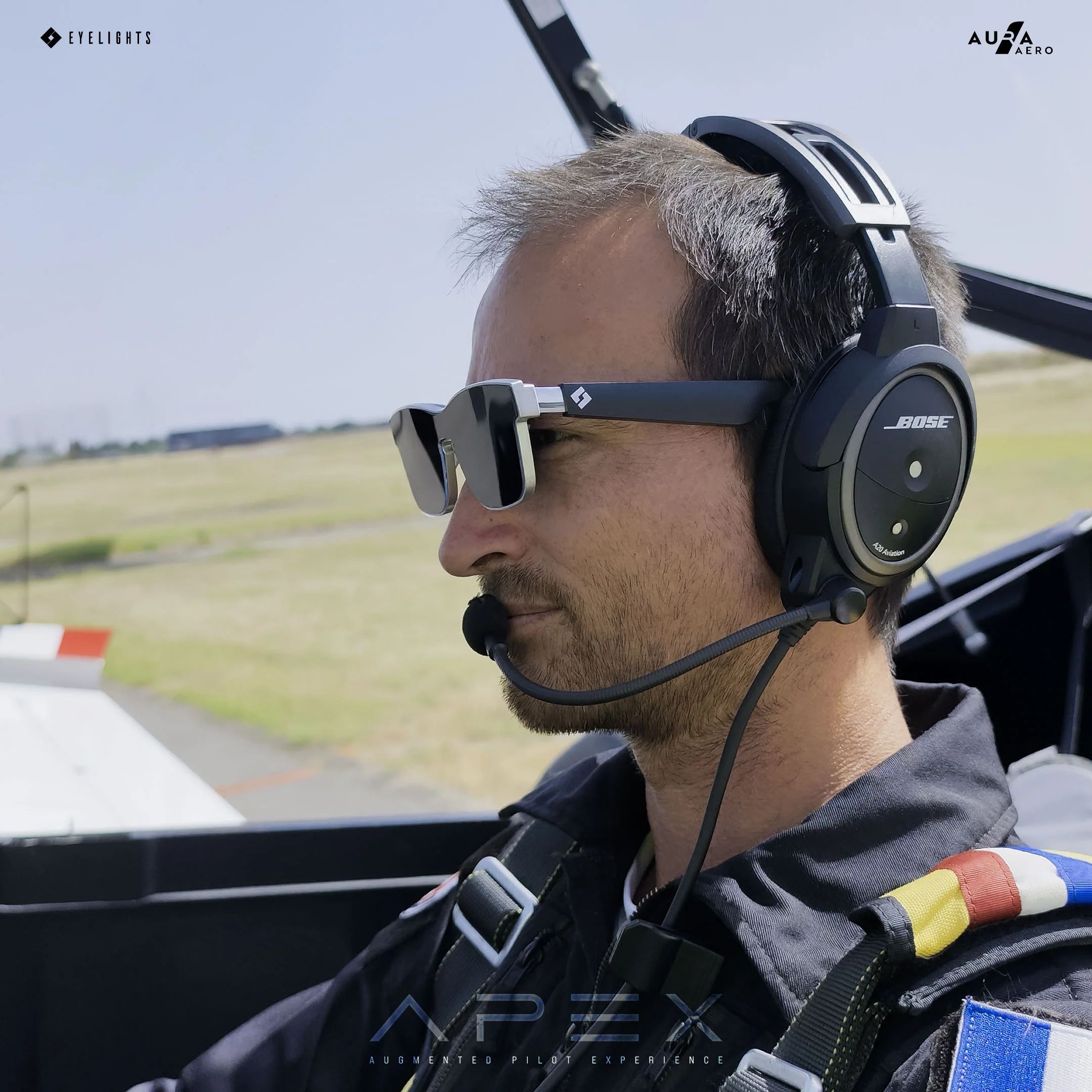 A pilot wearing the APEX HUD head-up display glasses in the cockpit.